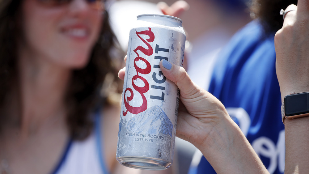 Person holding a can of Coors Light