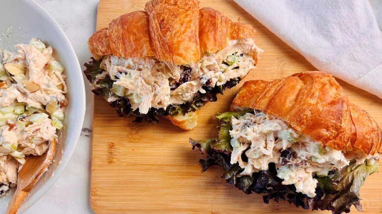 Croissant chicken salad sandwiches on wooden board