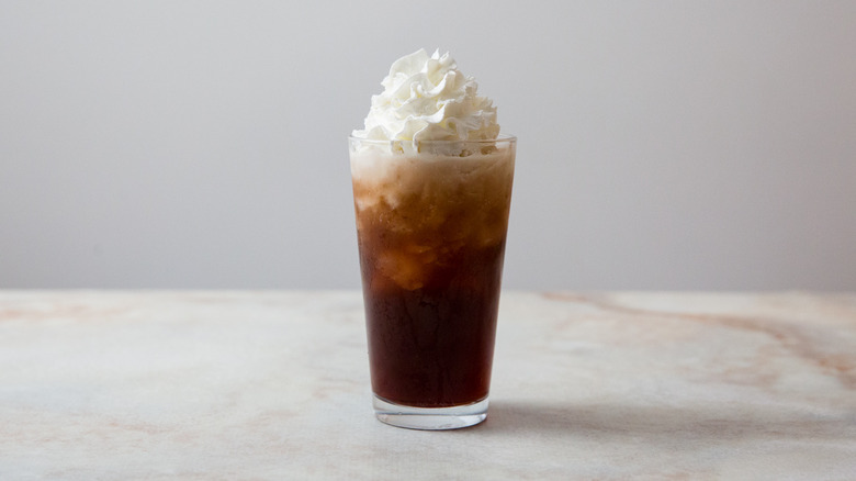 dirty soda in glass with whipped cream