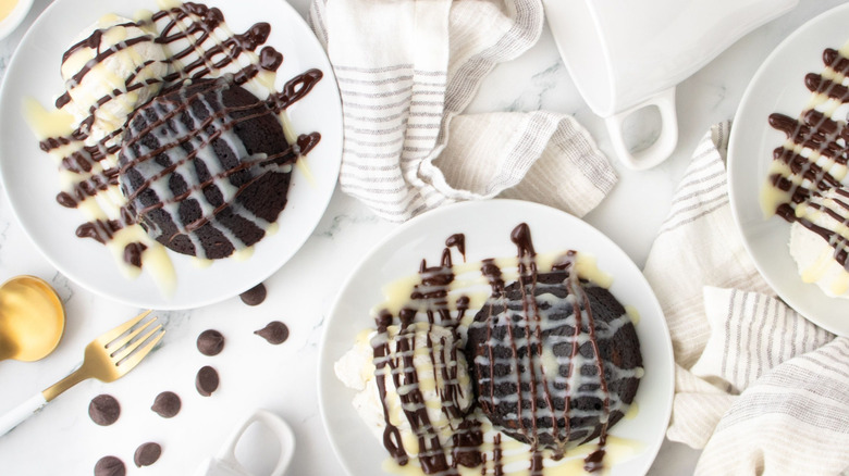Chocolate lava cakes with ice cream on plates