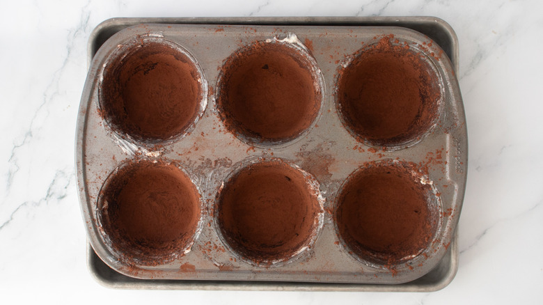 muffin pan coated with cocoa powder