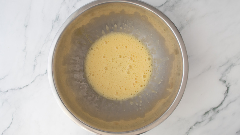 beaten eggs in a metal bowl