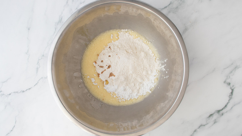 beaten eggs and flour in a metal bowl