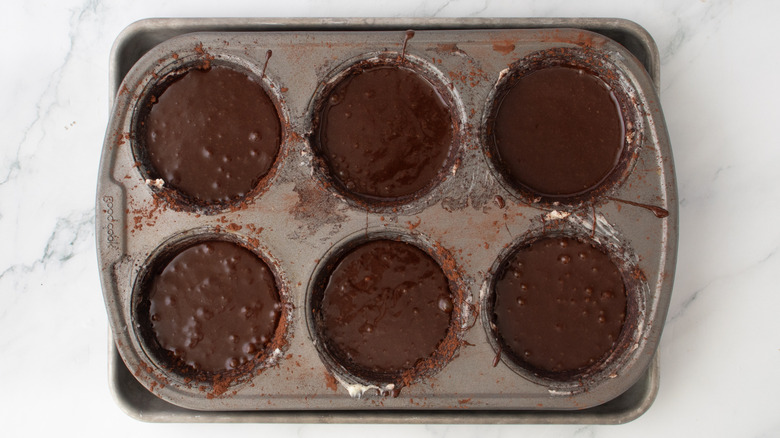 chocolate cake batter in a muffin pan