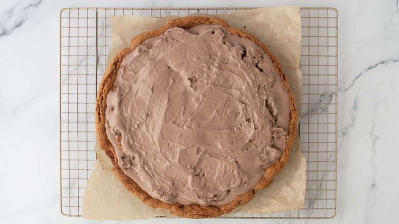 Ice cream cookie crust pizza sitting on wire rack