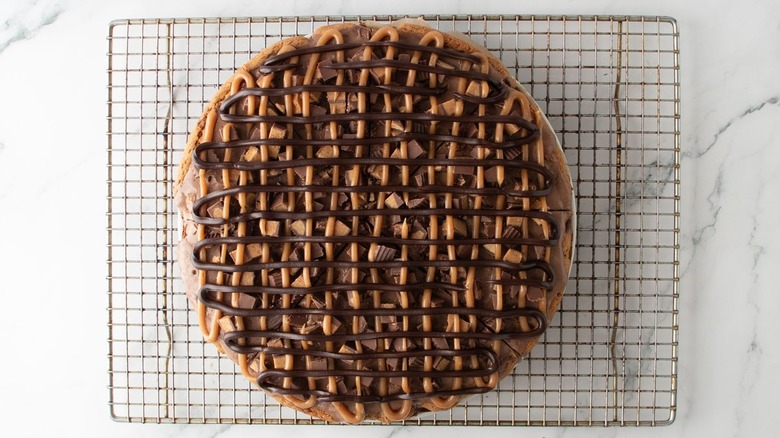 Chocolate peanut butter ice cream cookie pizza on wire rack