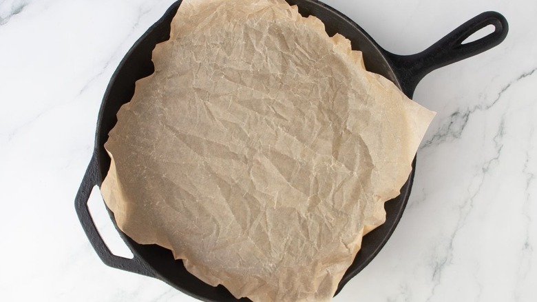 Cast iron skillet lined with parchment paper