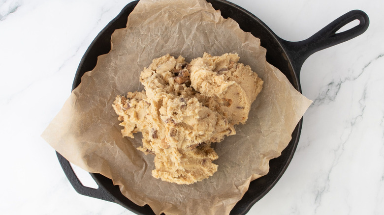Cookie dough sitting in cast iron skillet