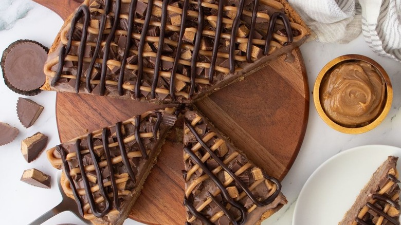 Chocolate peanut butter Polar Pizza sliced on wooden board