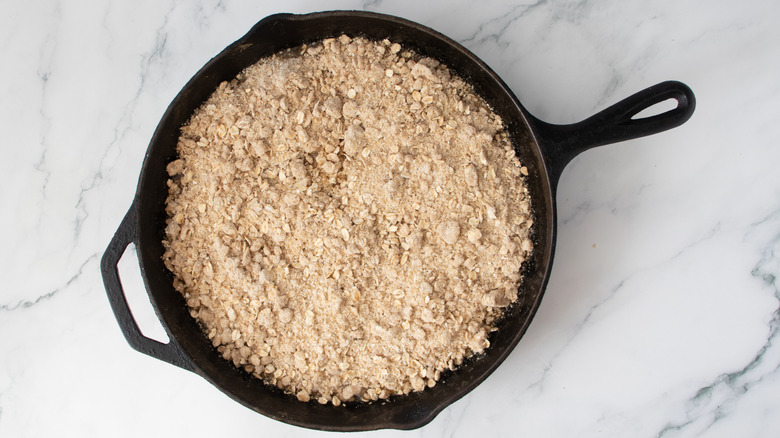 oat mixture in a black frying pan