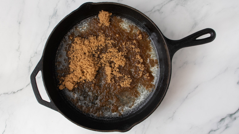melted butter and brown sugar in a black frying pan