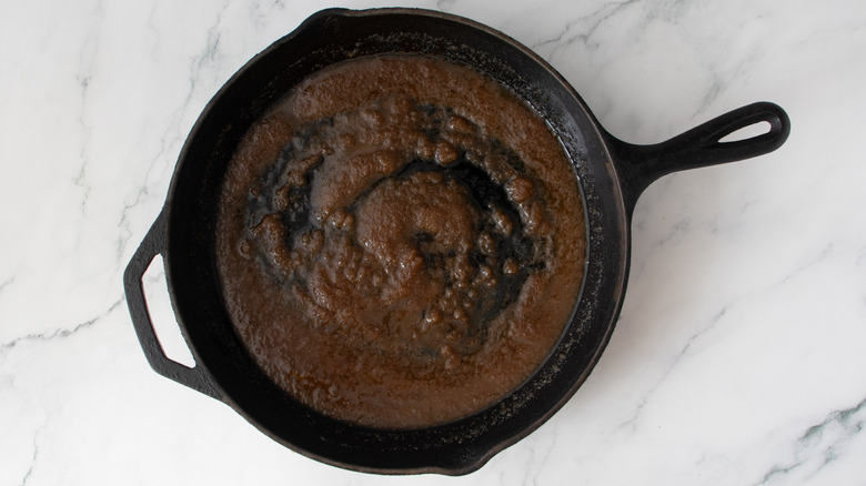 thick brown liquid in a black frying pan