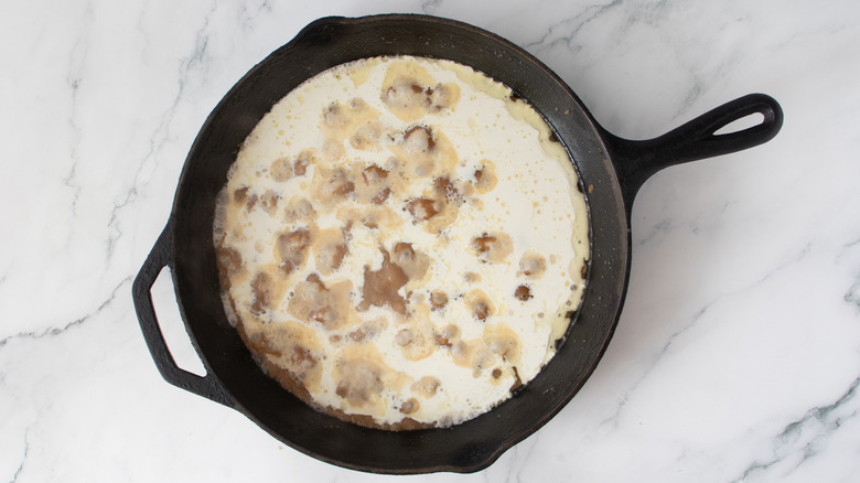 white and brown liquid in a black frying pan