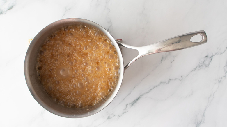 Bubbling caramel in saucepan