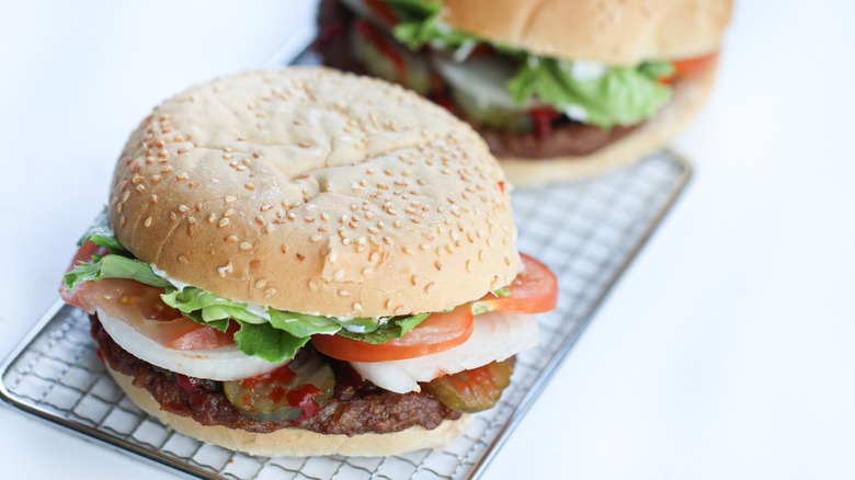 Two burgers places on a tray.