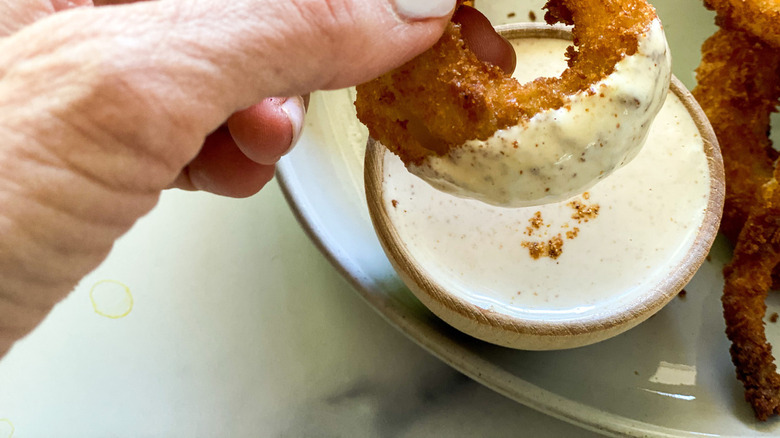 hand holding onion ring