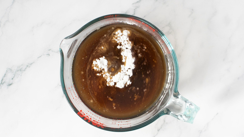 Unmixed kung pao sauce in measuring cup