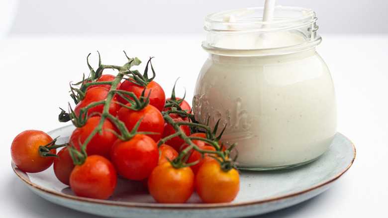 Copycat Chart House blue cheese dressing next to cherry tomatoes