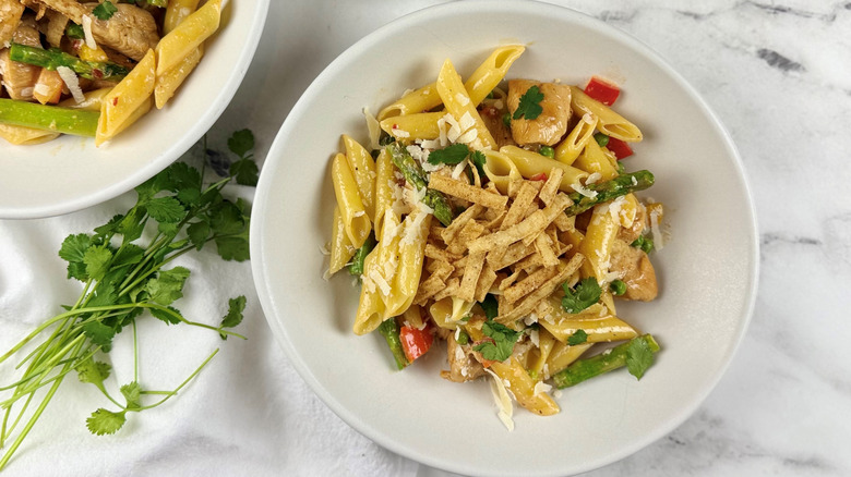 chicken, vegetables, and pasta in a white bowl