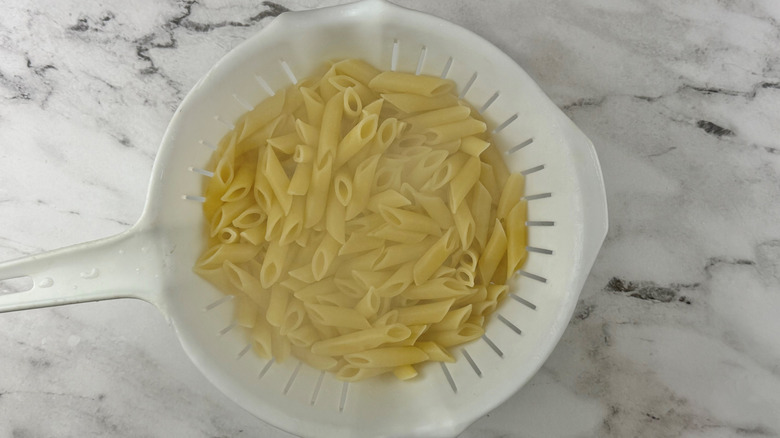 cooked noodles in a colander