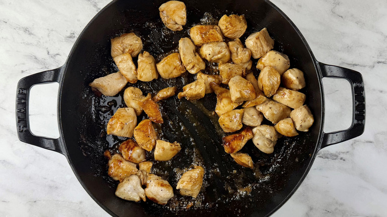 cooked chicken in a black frying pan
