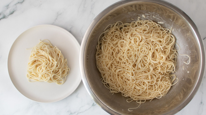Angel hair pasta on plate and in bowl