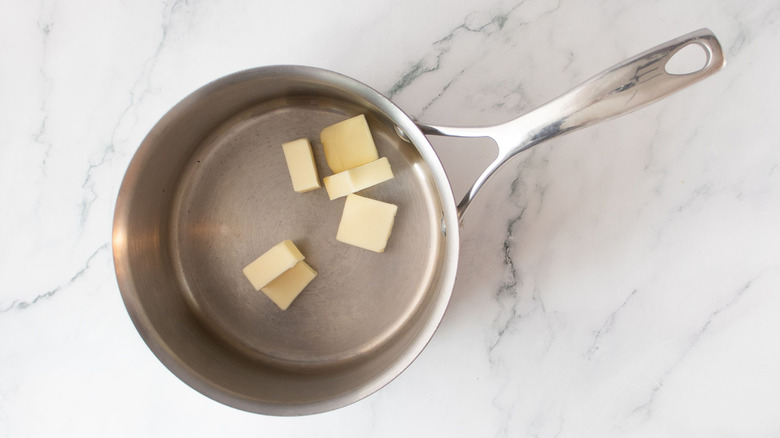 Pats of butter in saucepan