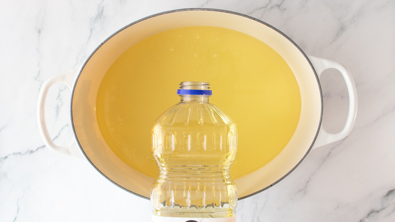 Oil pouring into large pot