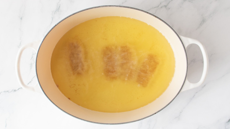 Mozzarella sticks frying in oil