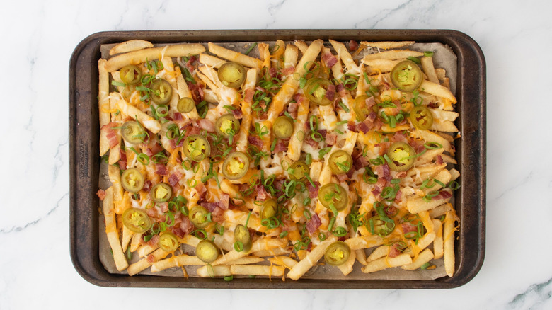 Loaded cheese fries on baking sheet