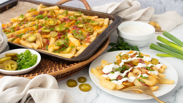 Chili's Texas cheese fries on baking sheet with serving on plate
