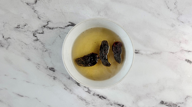 Dried peppers in bowl of water