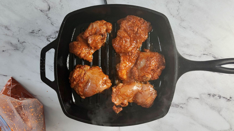 Marinated chicken thighs in grill pan