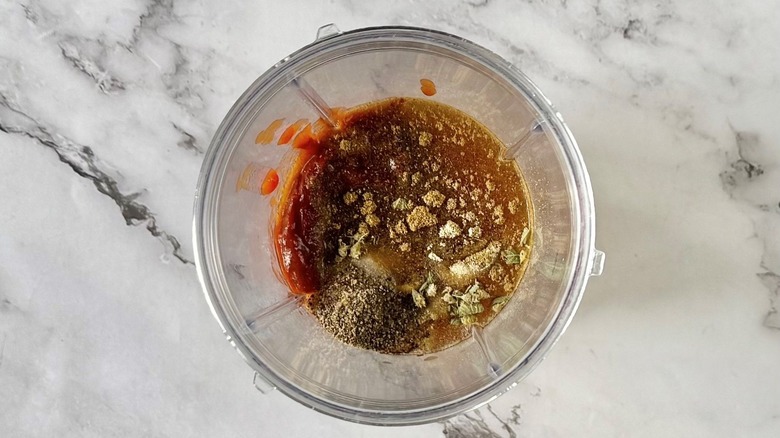 Various seasonings and sauce in blender