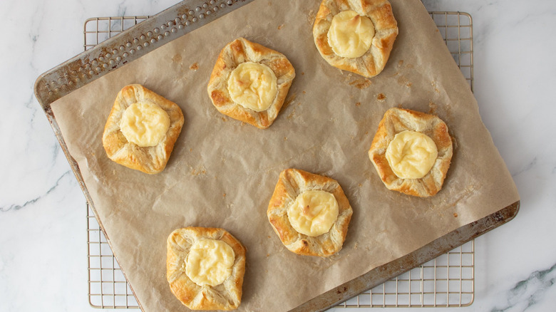 Cream cheese danishes on baking sheet on wire rack