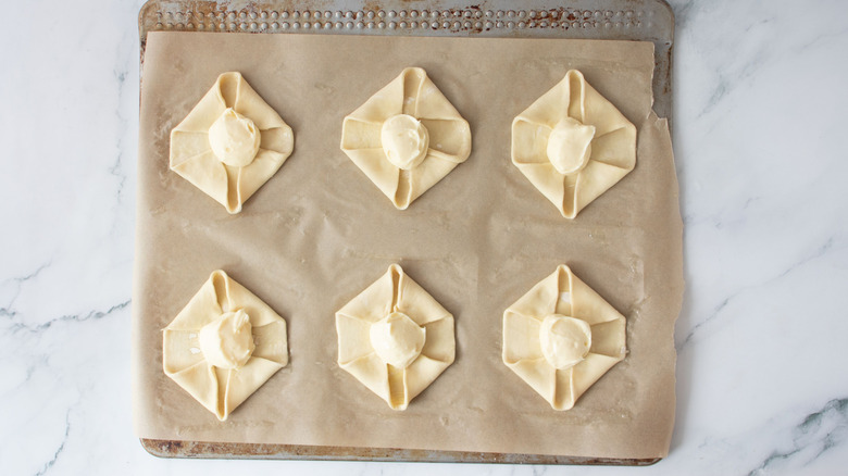 Unbaked danishes on baking sheet