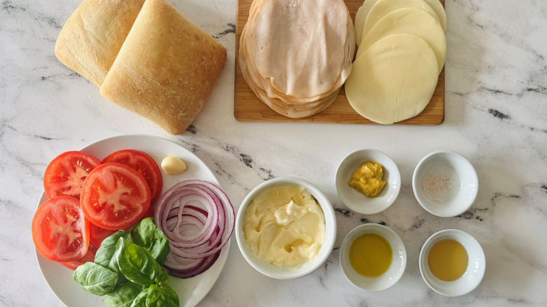 bread, cheese, turkey, vegetables, spices, and condiments