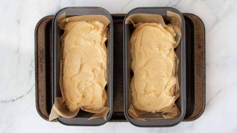 Two loaf pans filled with batter