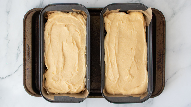 Two loaf pans filled with batter