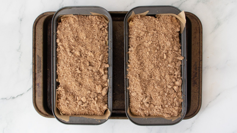 Unbaked crumb-topped coffee cakes in loaf pans