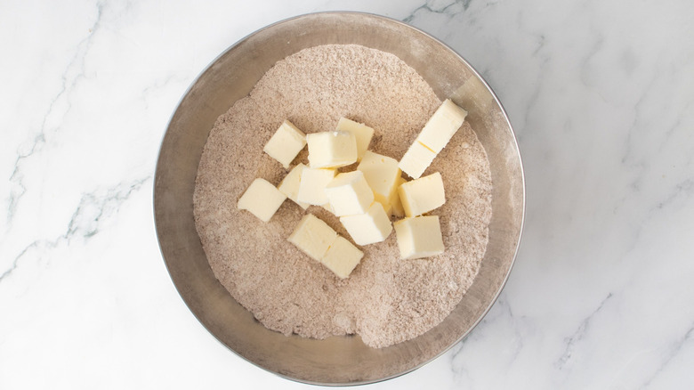 Flour mixture with butter cubes in bowl