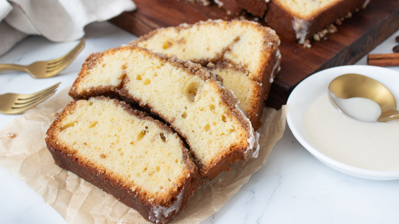 Coffee cake slices next to bowl of icing