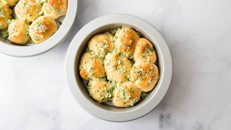 Parmesan garlic butter dinner rolls in pans