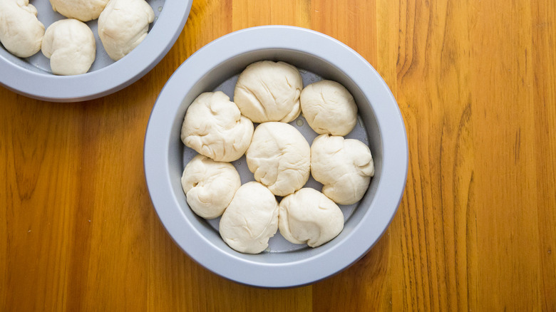 unbaked rolls in round pan