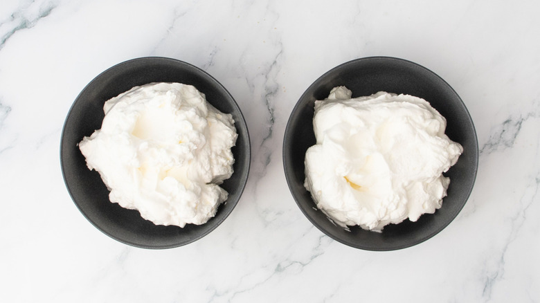 Whipped cream in two bowls