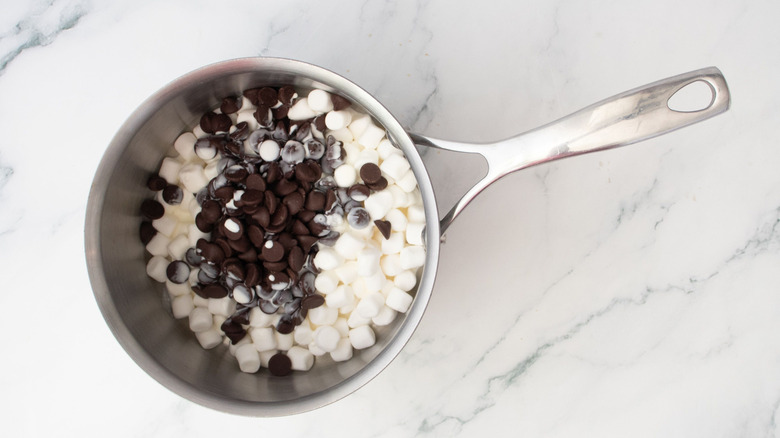 Dark chocolate chips and mini marshmallows in saucepan