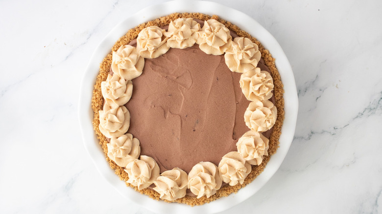 Chocolate mousse pie with peanut butter mousse piping on top