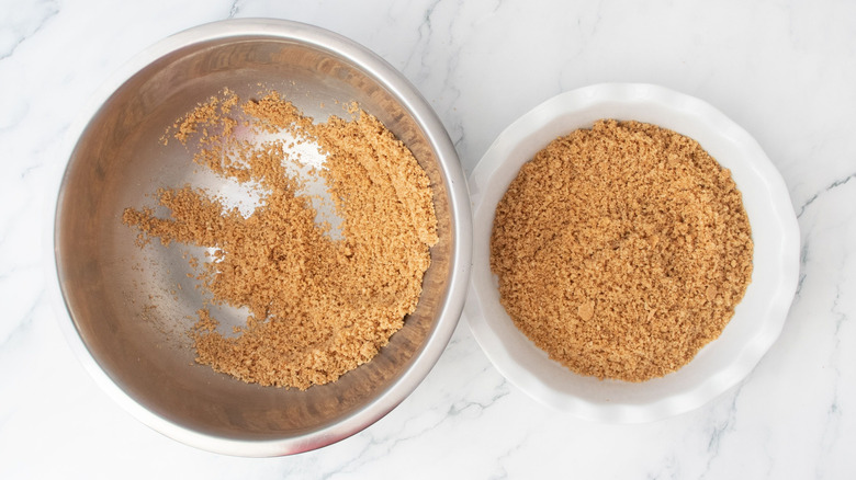 Graham cracker crumbs in bowl and in pie dish