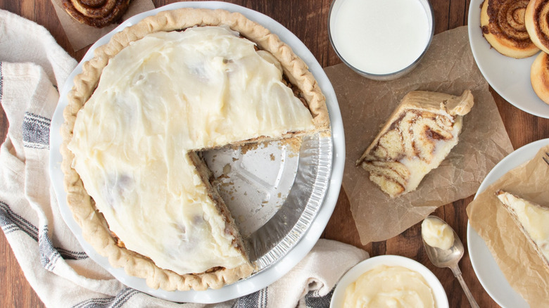 Cinnamon roll pie in tin with slices removed