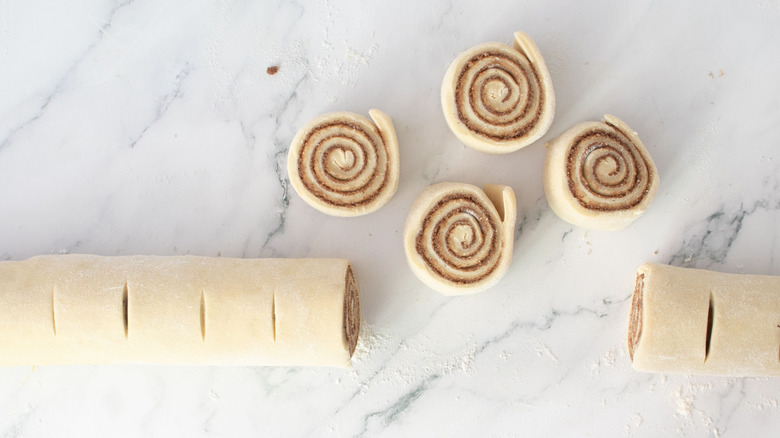 Cinnamon roll log with some cinnamon rolls cut out